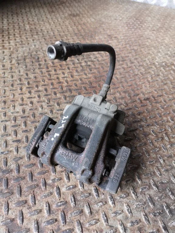 Rear brake caliper – left