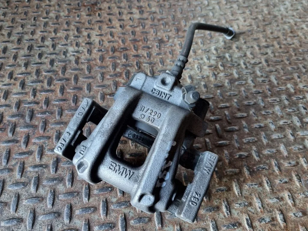 Rear brake caliper – left