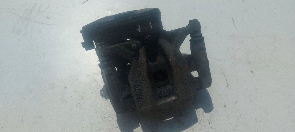 Rear brake caliper – left