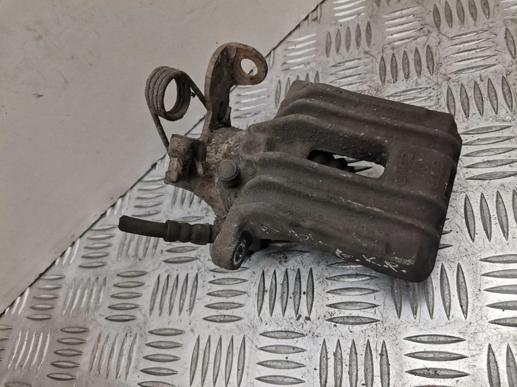 Rear brake caliper – left