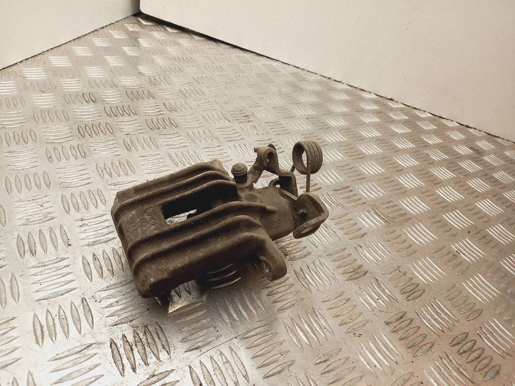 Rear brake caliper – left