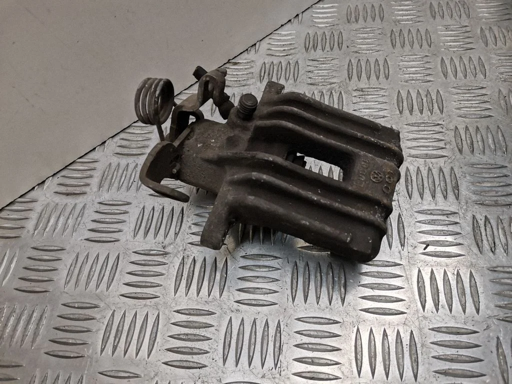 Rear brake caliper – left