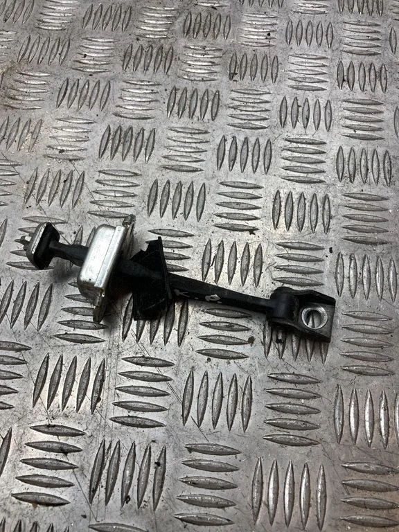 Front door check strap stopper – left