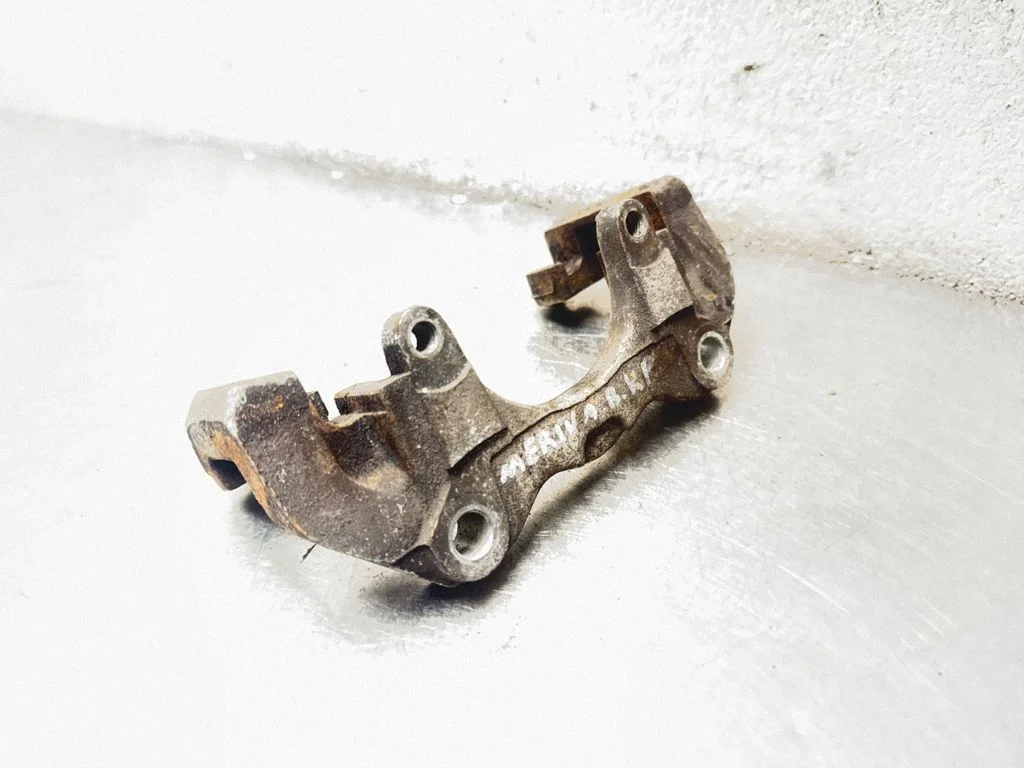 Front Brake Caliper Pad/Carrier – front left