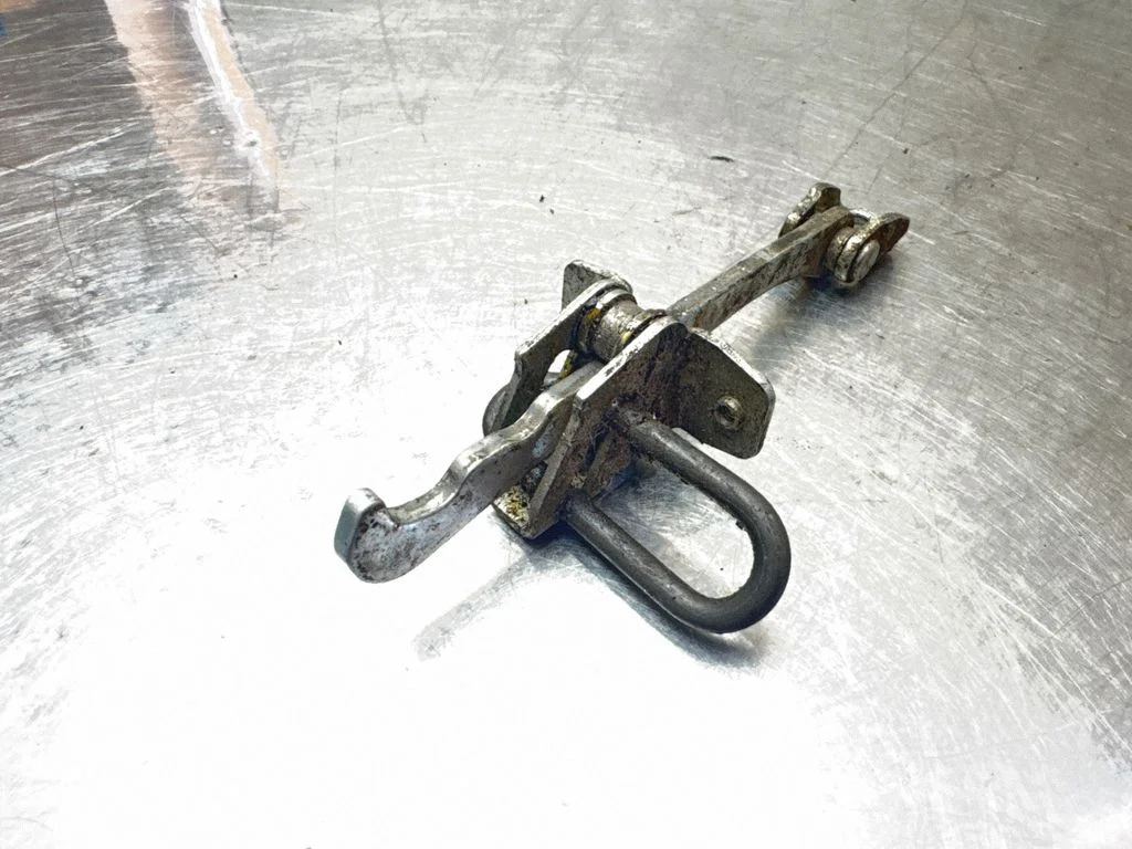 Front door check strap stopper 24434087