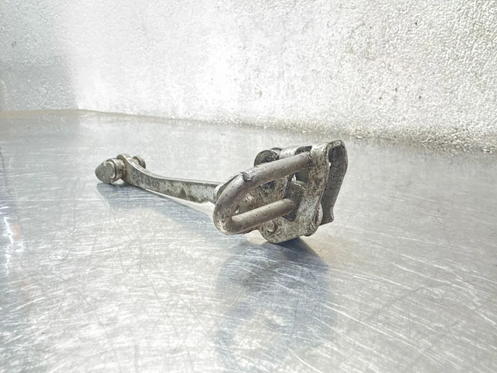 Front door check strap stopper 24434087