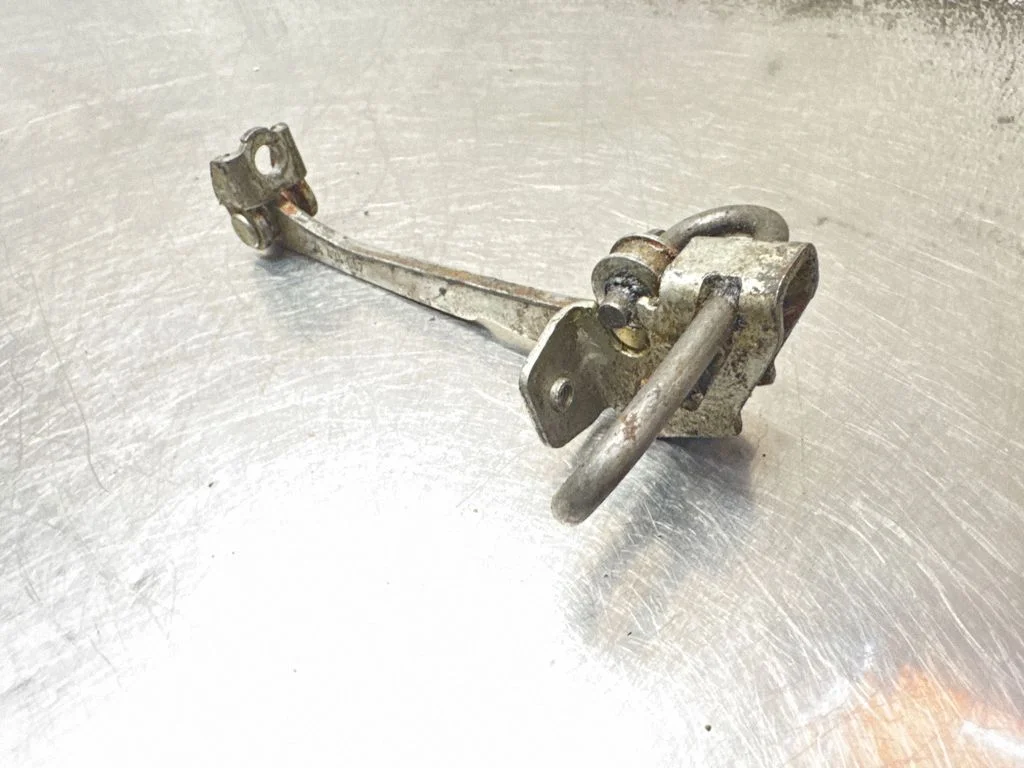 Front door check strap stopper 24434087