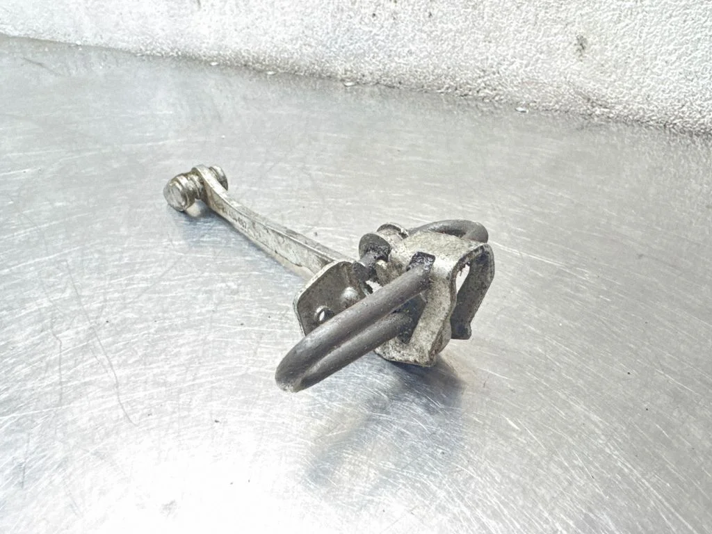 Front door check strap stopper 24434087