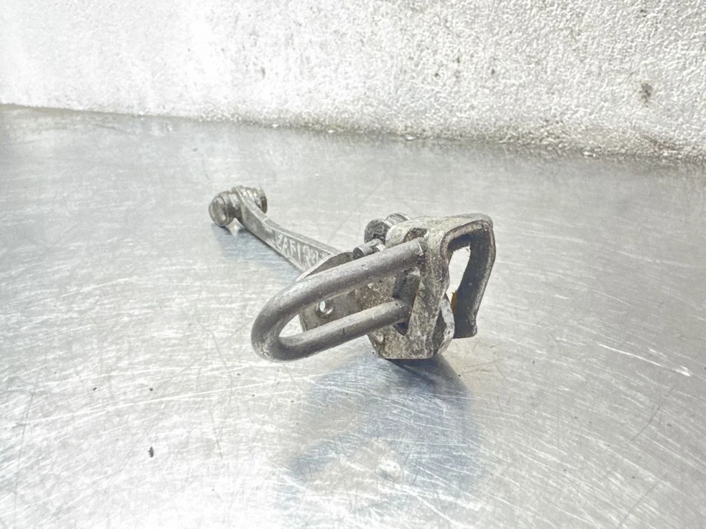 Front door check strap stopper 24434087