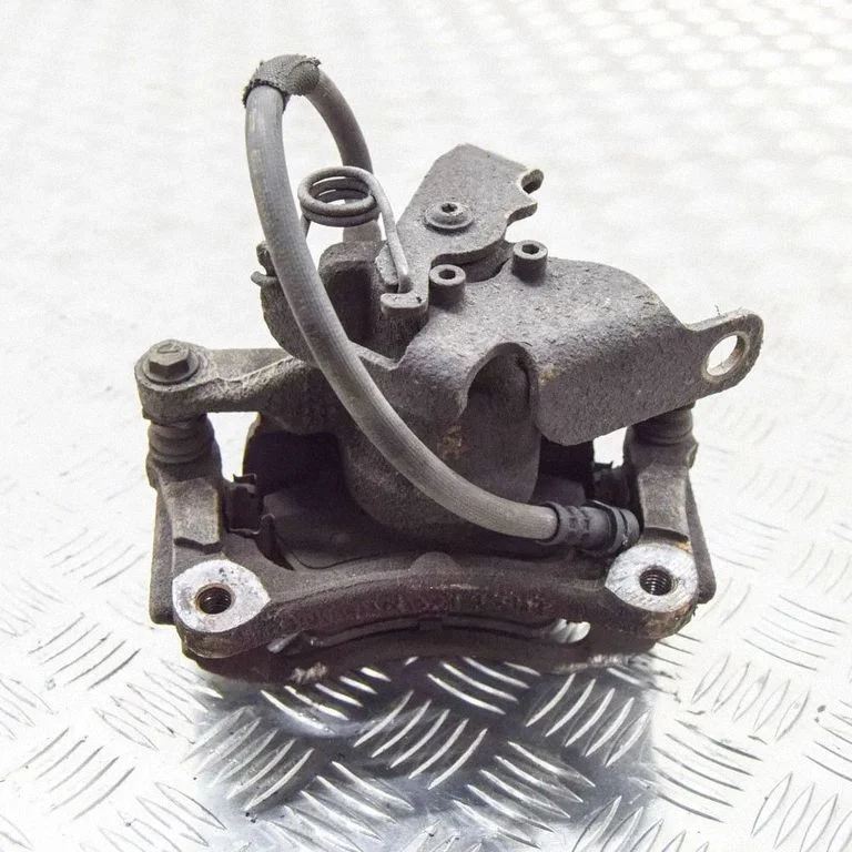 Rear brake caliper – left