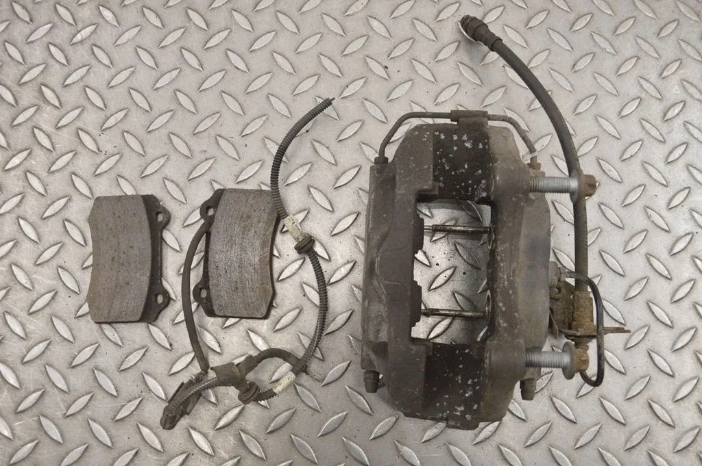 Rear brake caliper – left