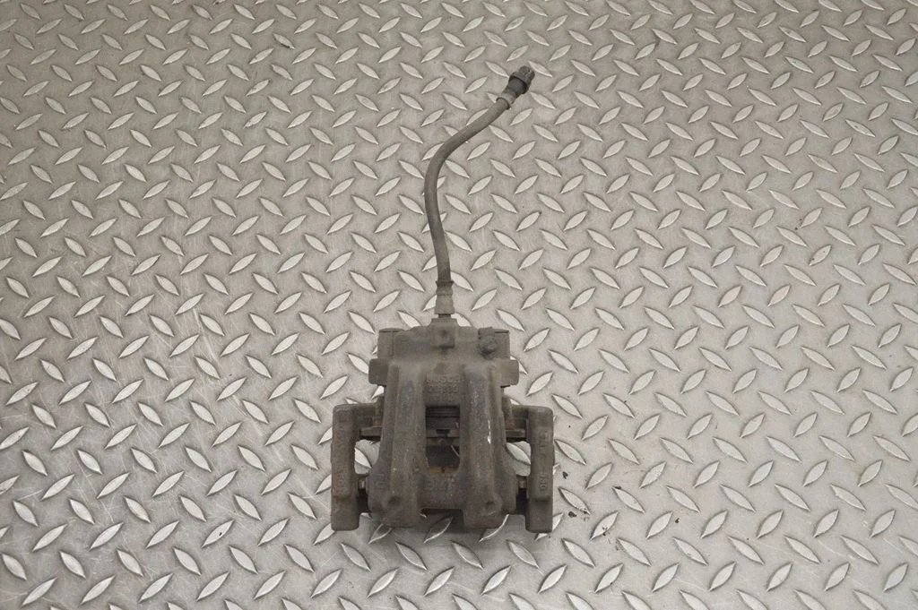 Rear brake caliper – left