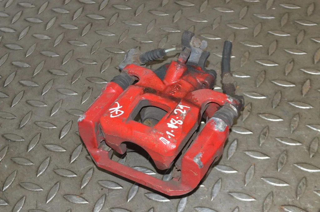 Rear brake caliper – left