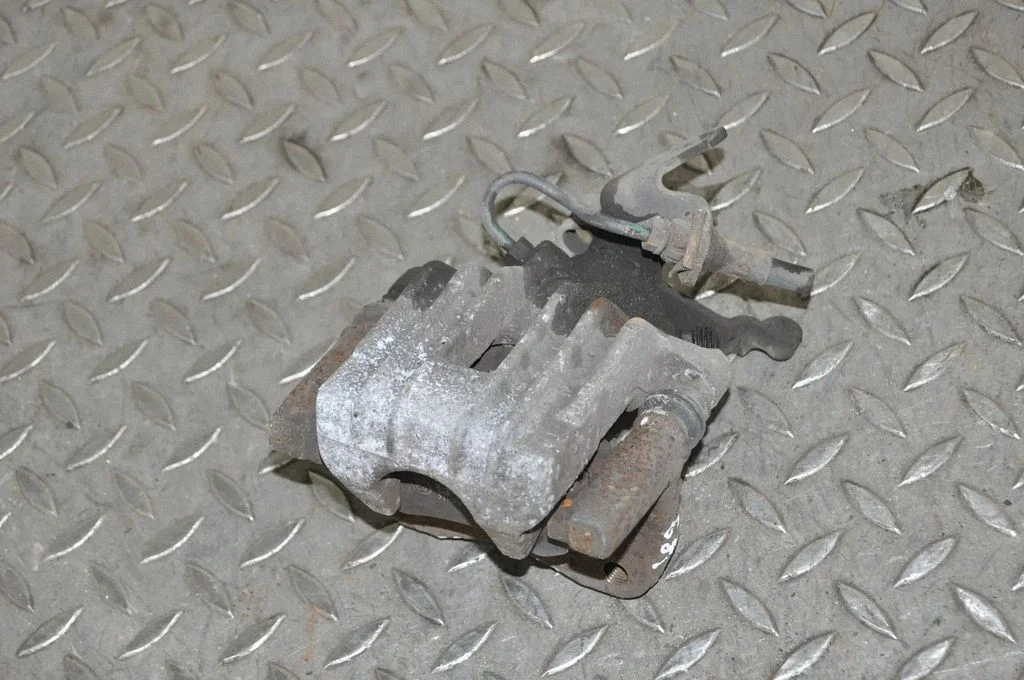 Rear brake caliper – left