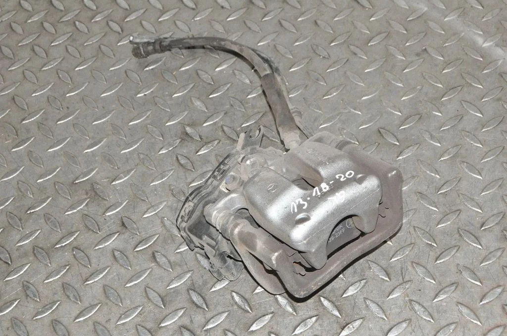 Rear brake caliper – left