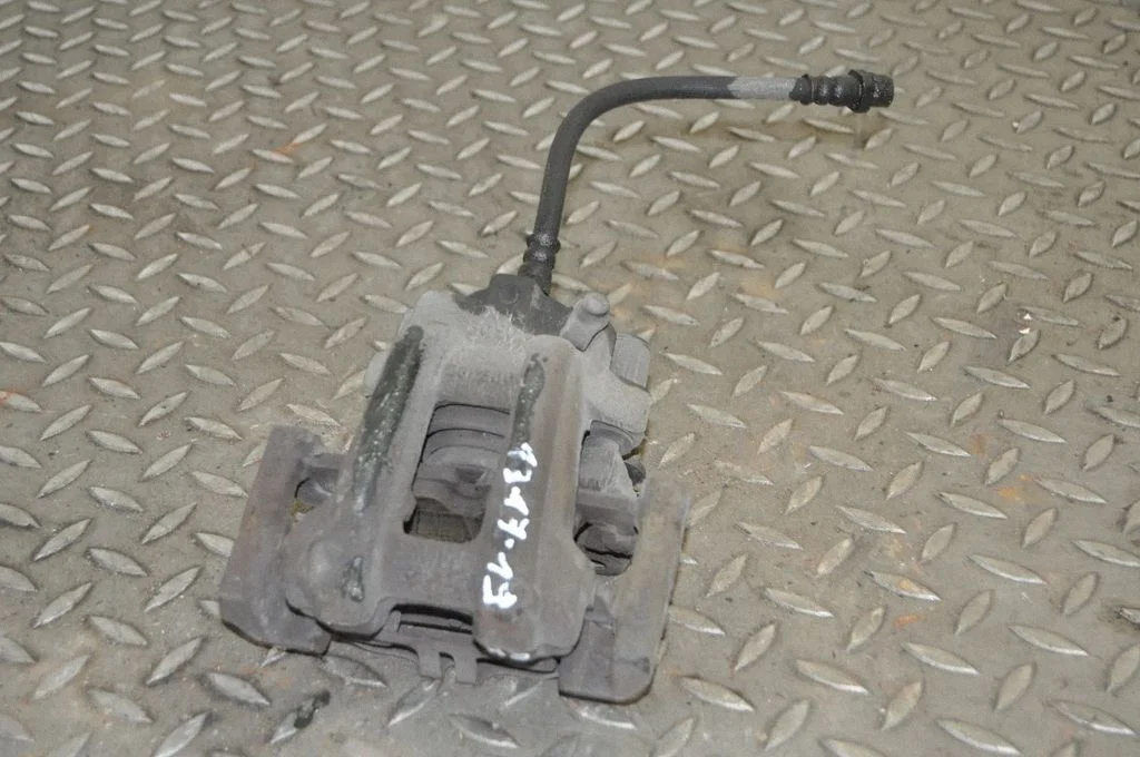 Rear brake caliper – left