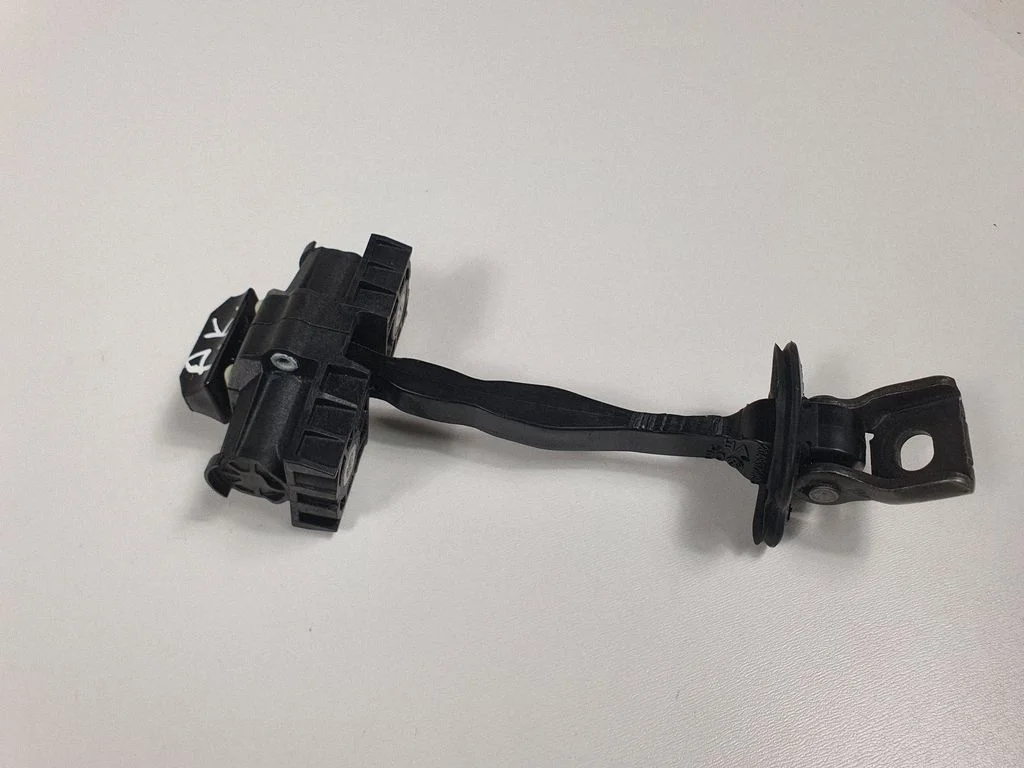 Front door check strap stopper – front left