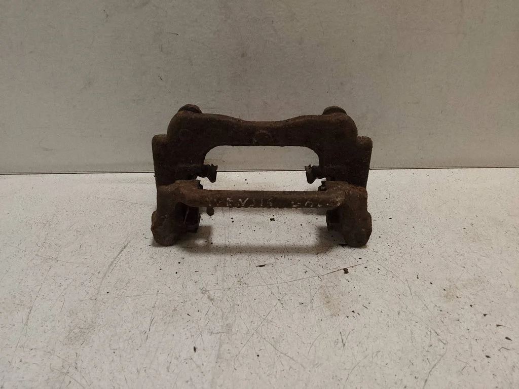 Brake caliper pad carrier rear – left