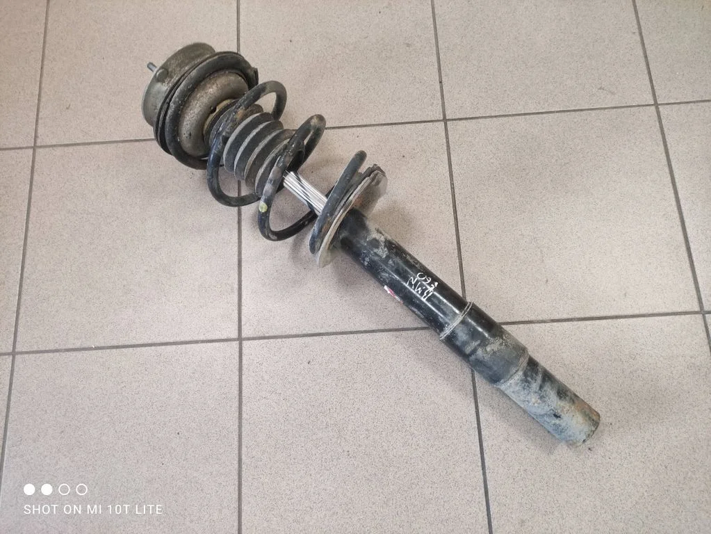 Front shock absorber with coil spring – left