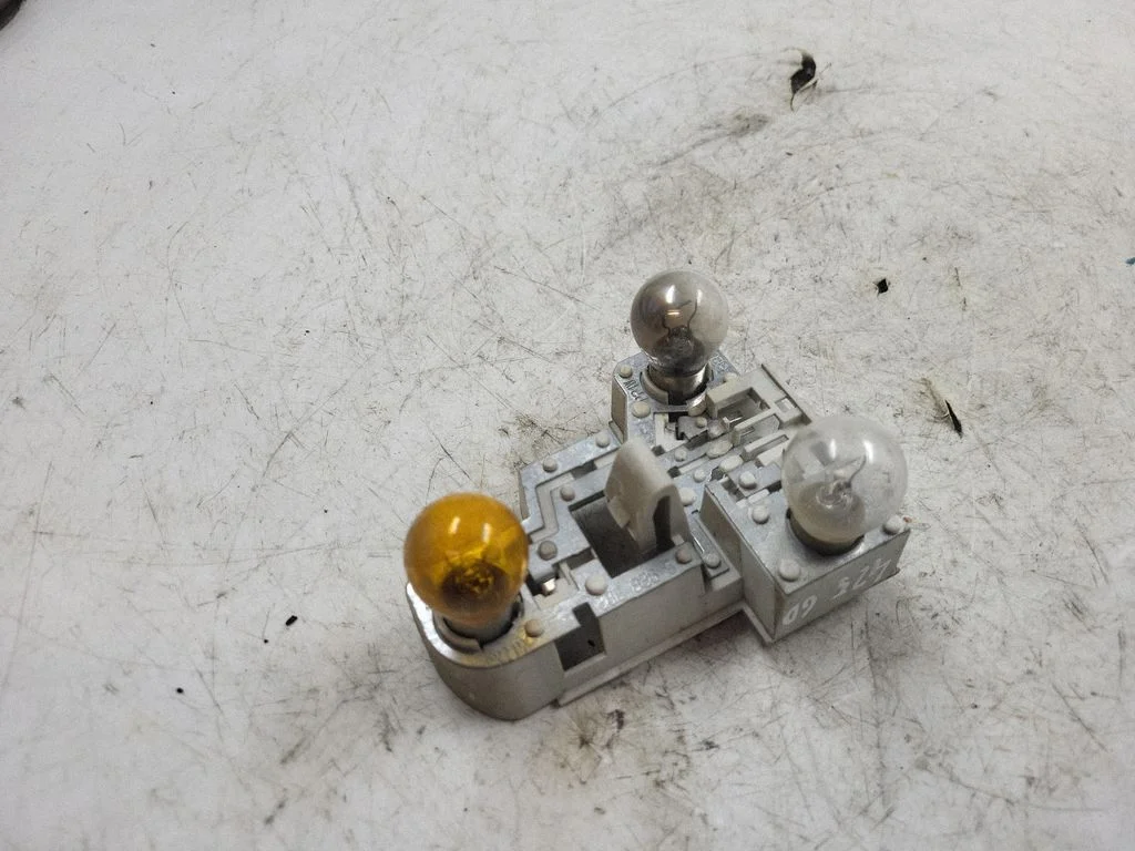 Tail light bulb cover holder – rear right