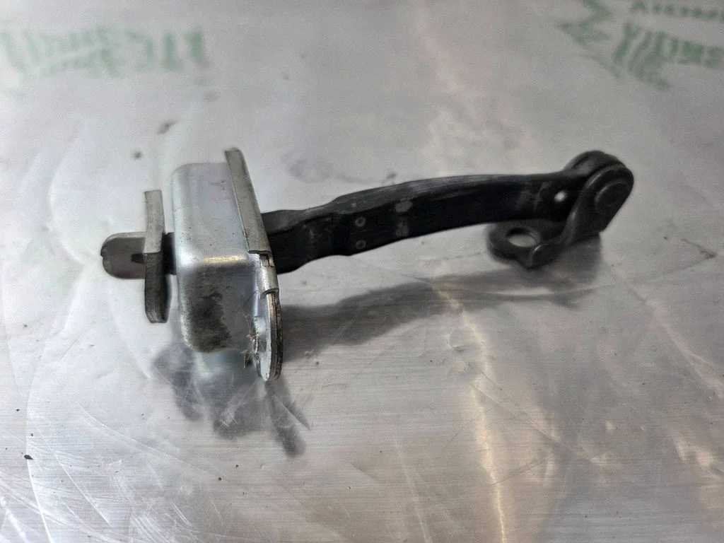 Front door check strap stopper