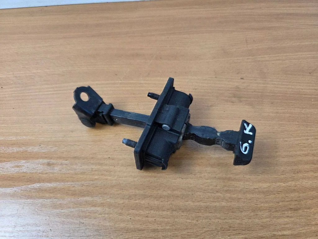 Rear door check strap stopper – rear left