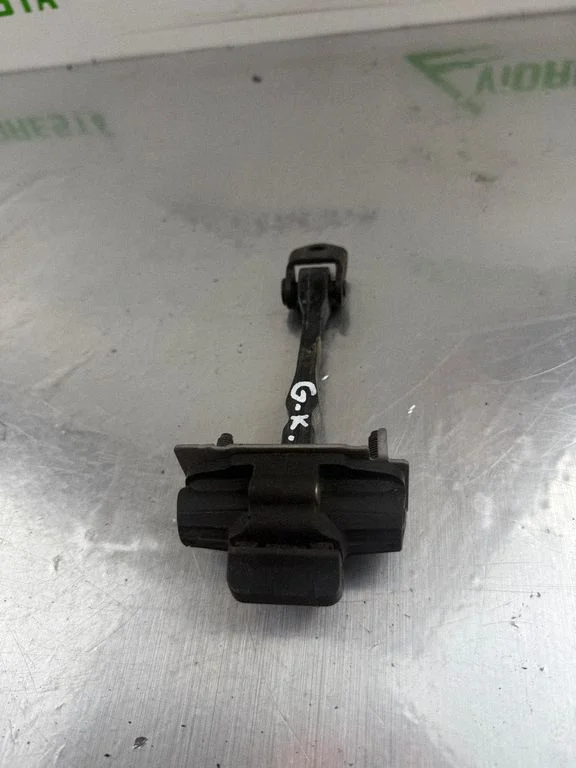 Rear door check strap stopper – rear left