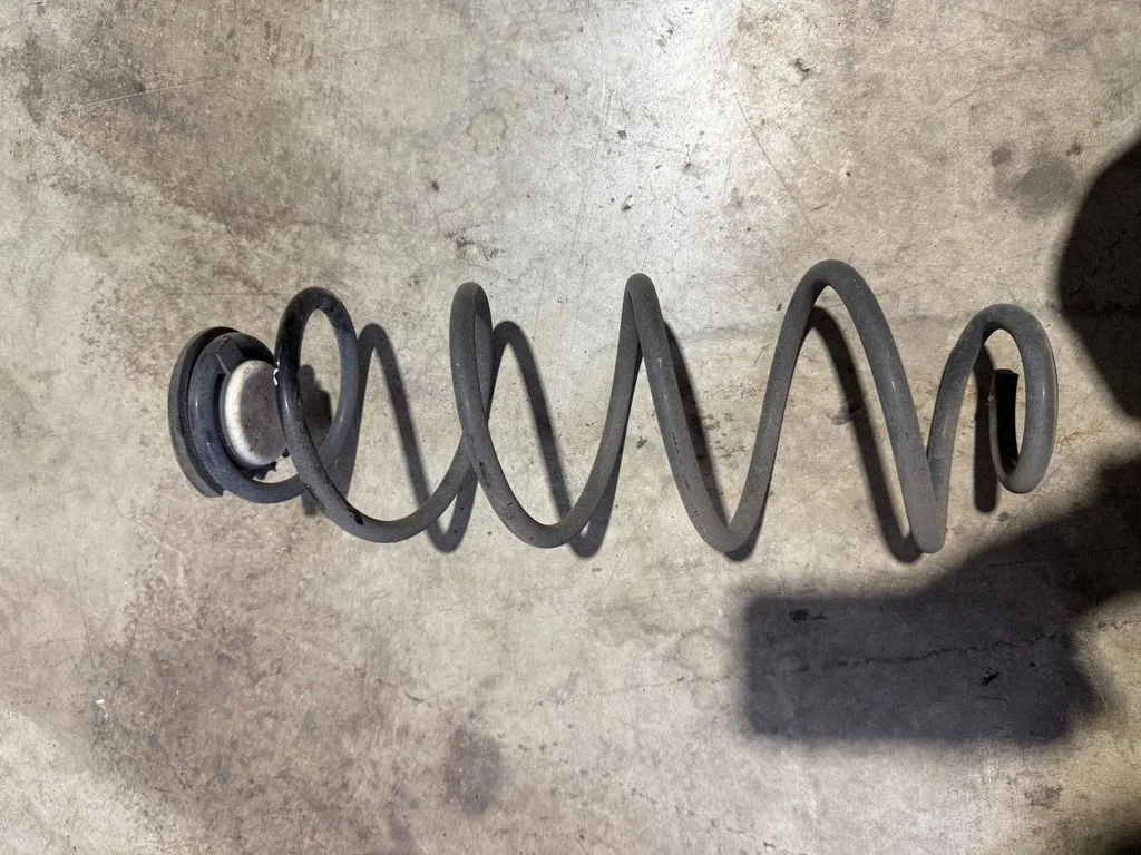 Rear coil spring – left