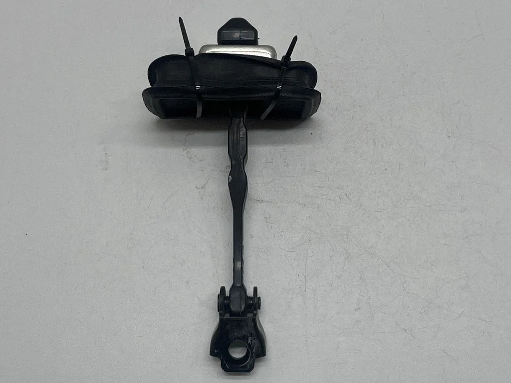 Front door check strap stopper – front right