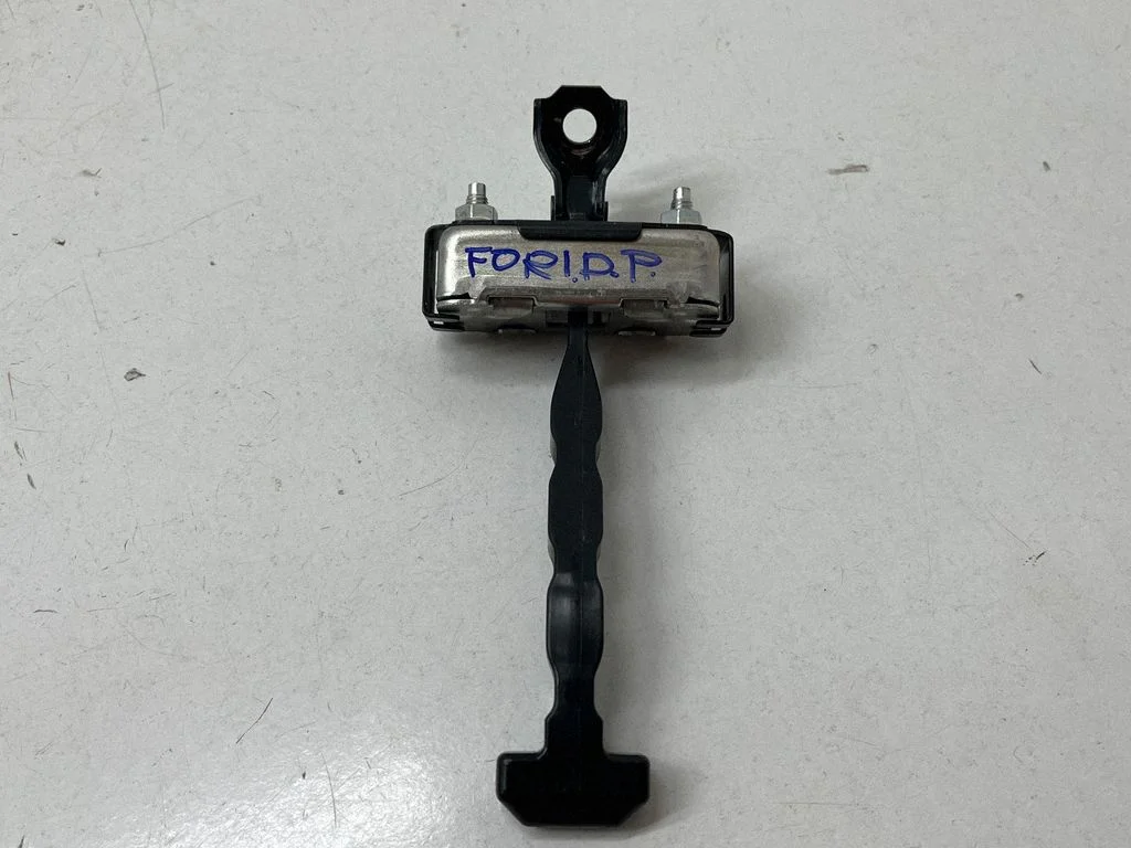 Rear door check strap stopper – front right