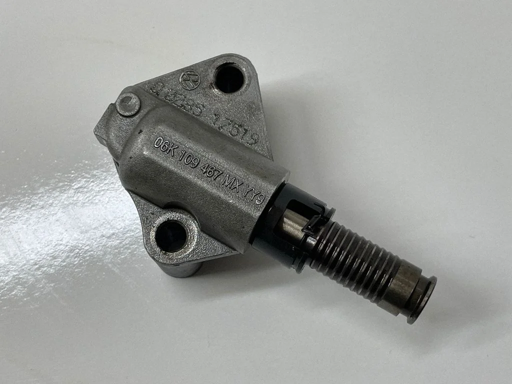 Timing belt/chain tensioner 06K109467