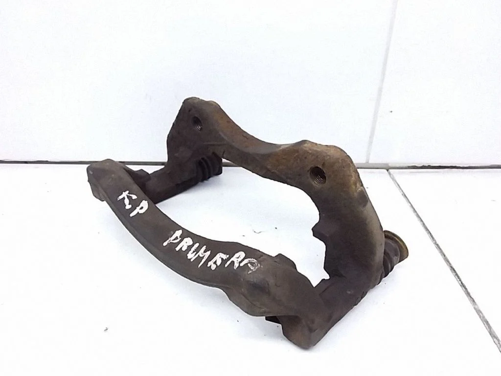 Front Brake Caliper Pad/Carrier – front left