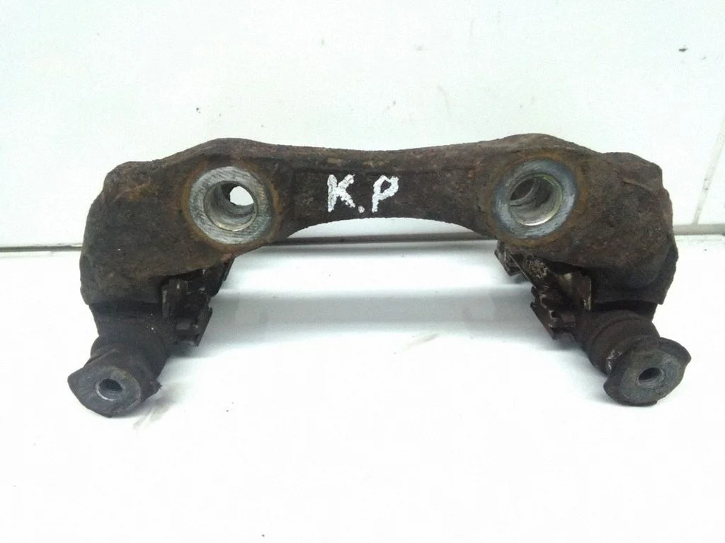 Front Brake Caliper Pad/Carrier – left