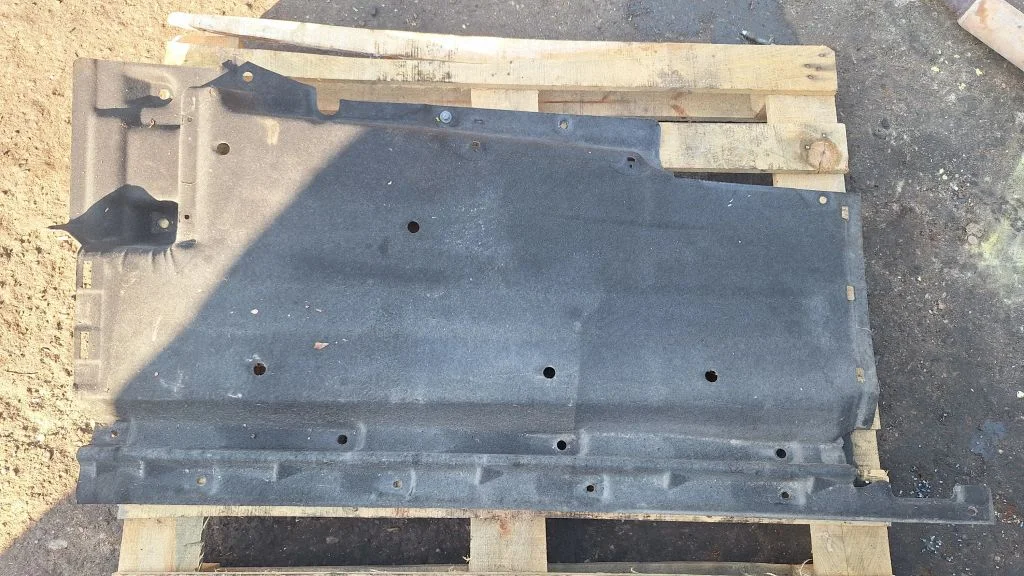 Center/middle under tray cover – left