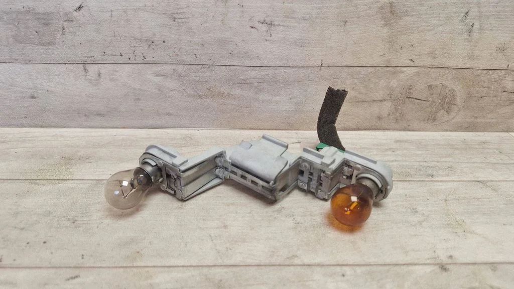 Tail light bulb cover holder – rear left