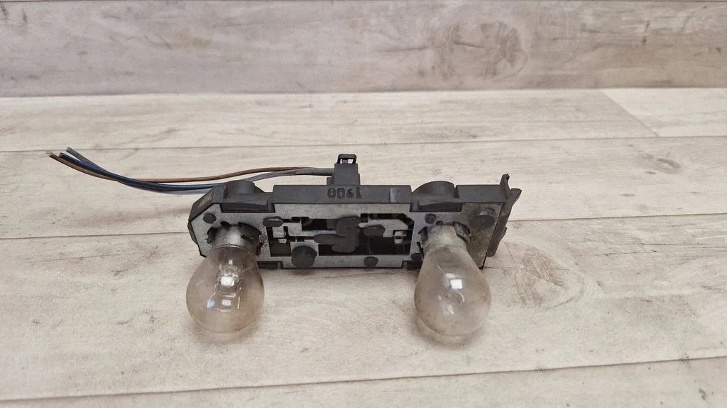 Tail light bulb cover holder 7M3945257A