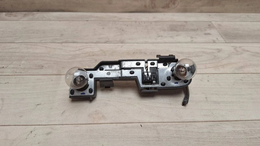 Tail light bulb cover holder 27482201