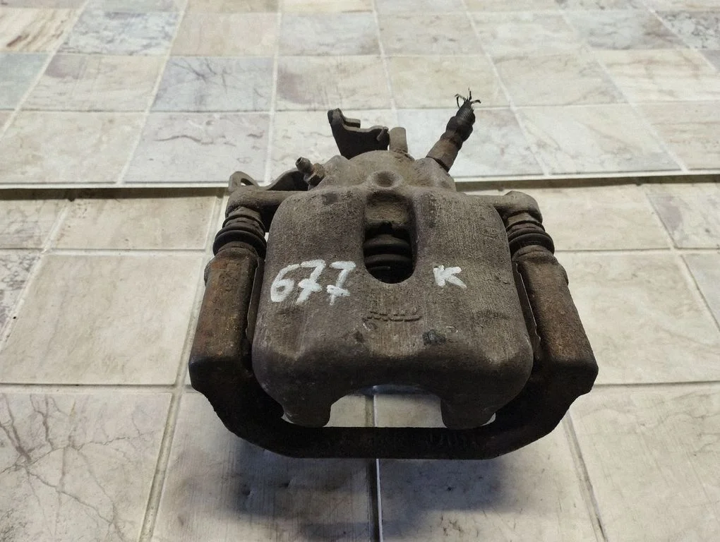 Rear brake caliper – left