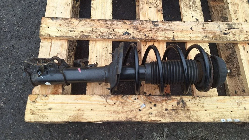 Front shock absorber with coil spring – front left