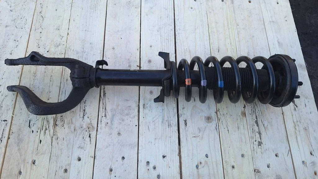 Front shock absorber with coil spring – front left