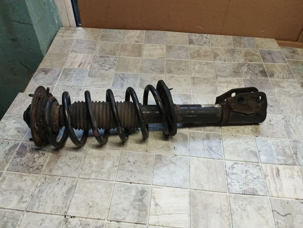Front shock absorber with coil spring – front left