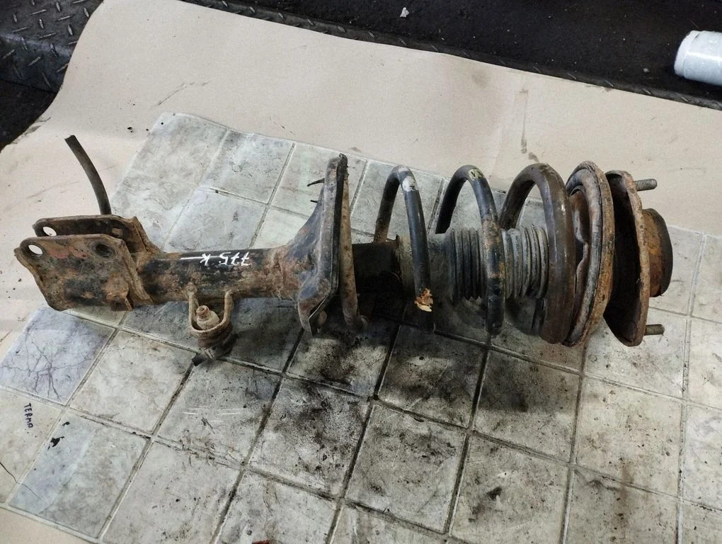 Front shock absorber with coil spring – front left