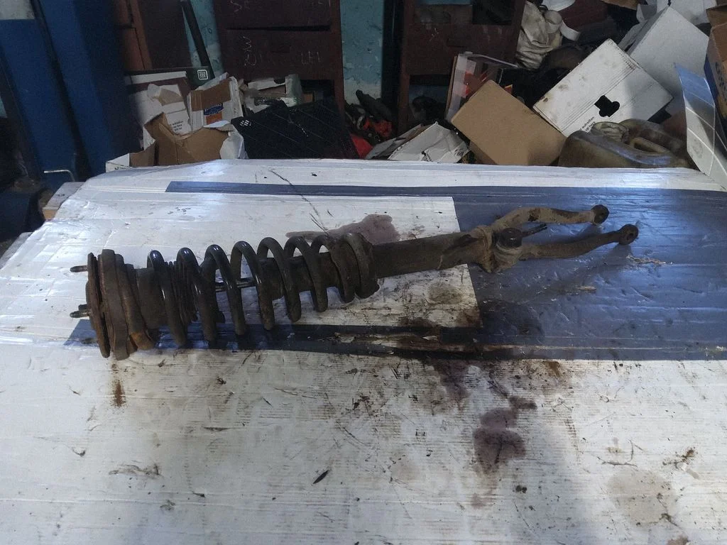 Front shock absorber with coil spring – left