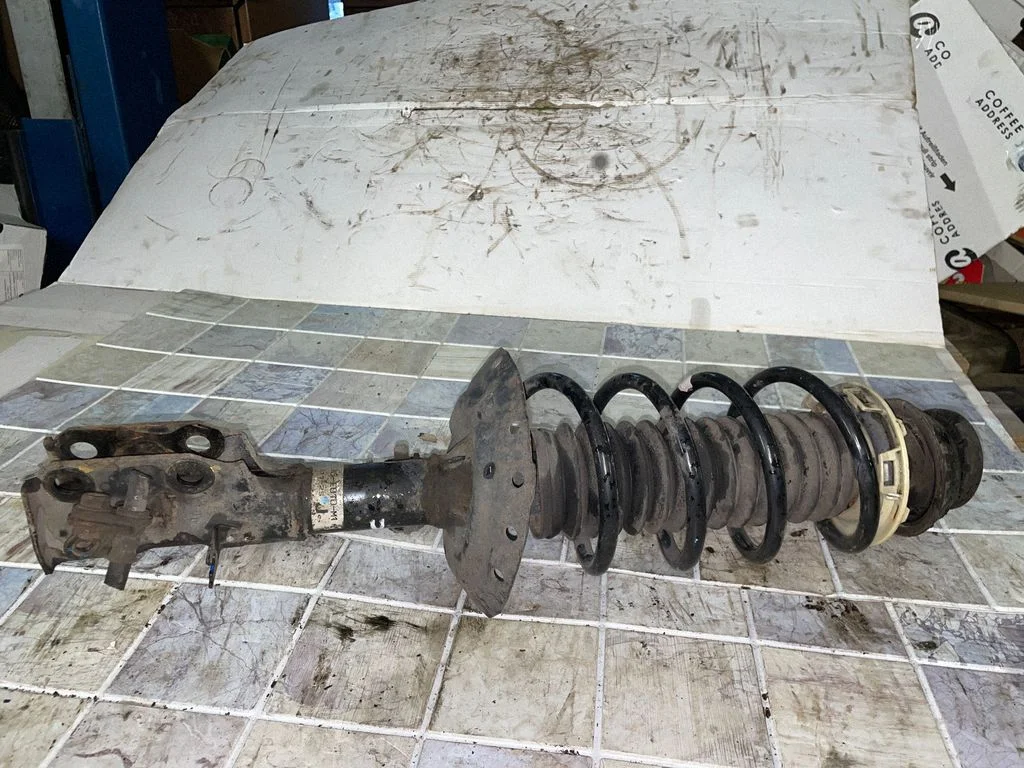 Front shock absorber with coil spring – left