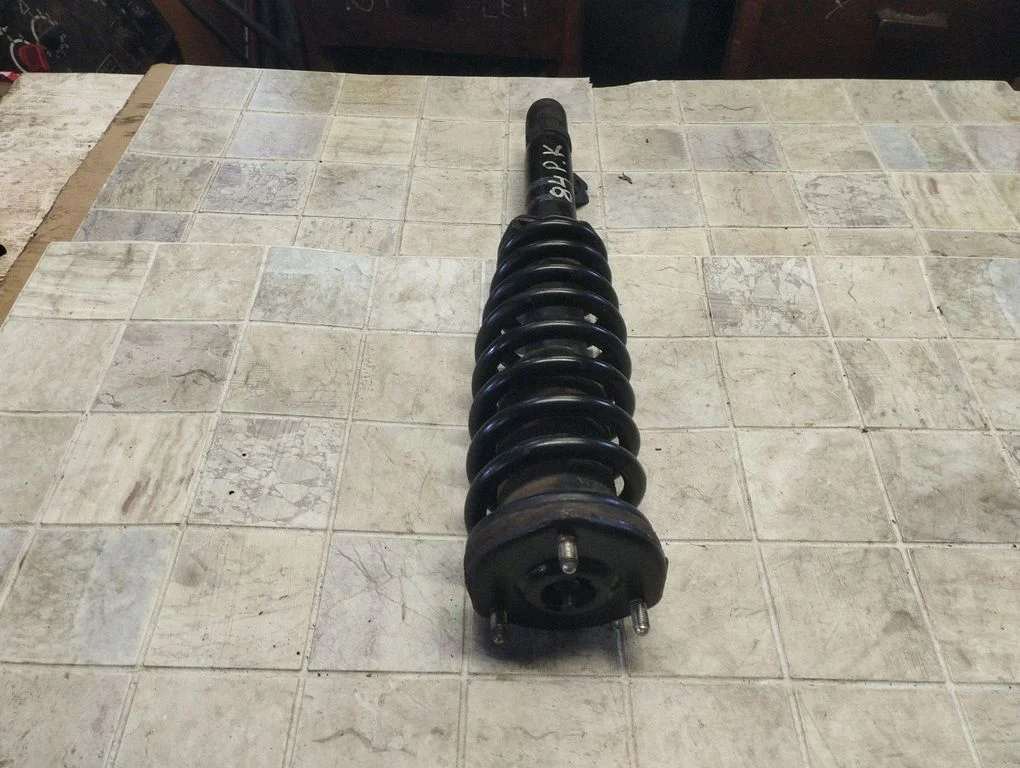 Front shock absorber with coil spring – front left
