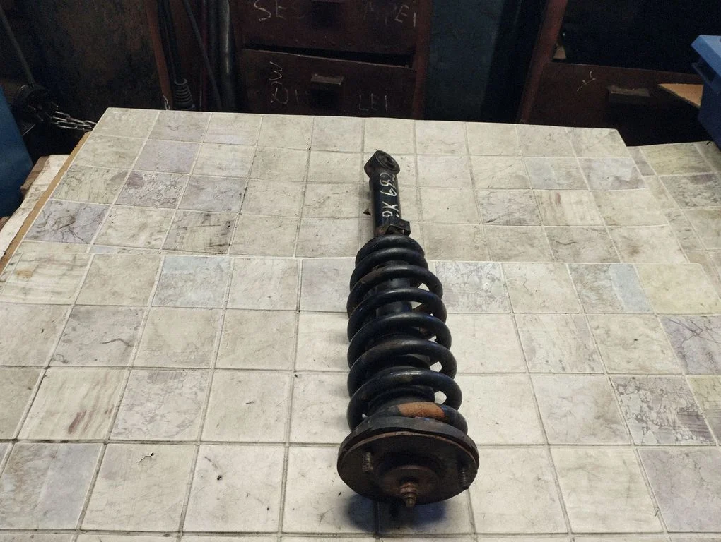 Front shock absorber with coil spring – front left