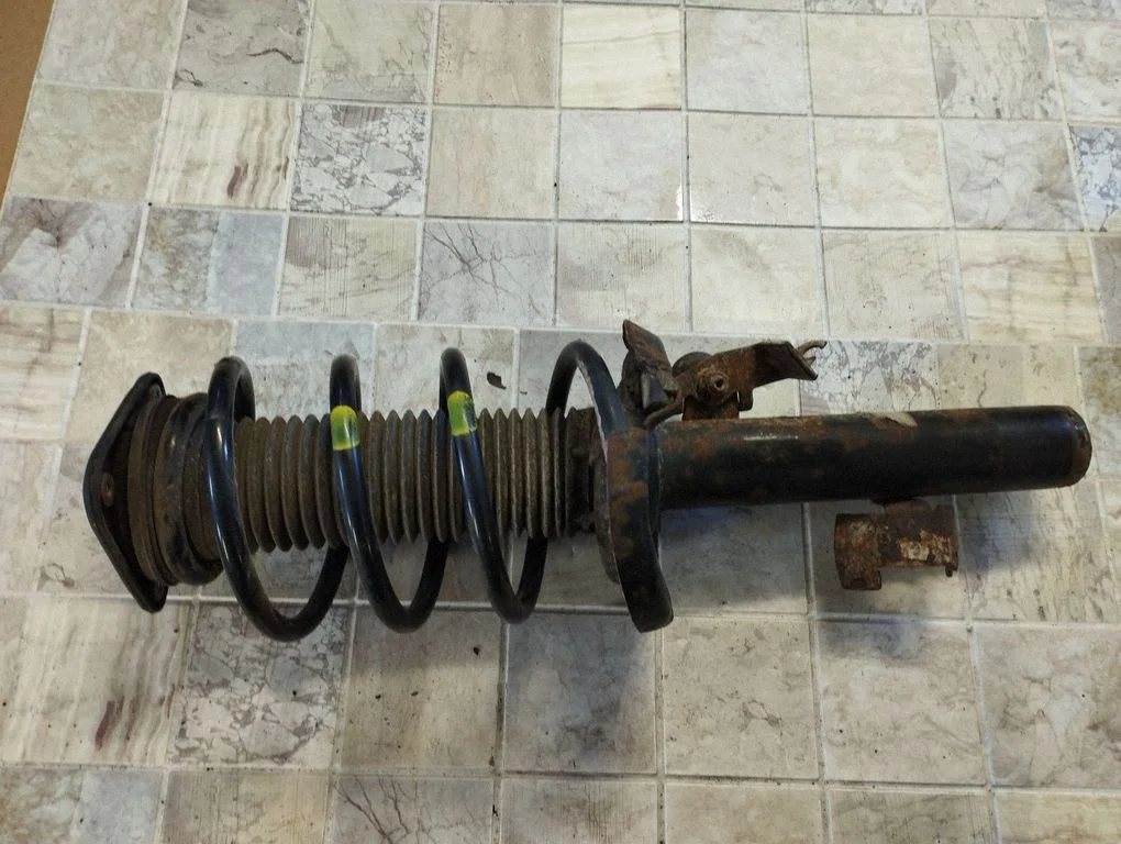 Front shock absorber with coil spring – left