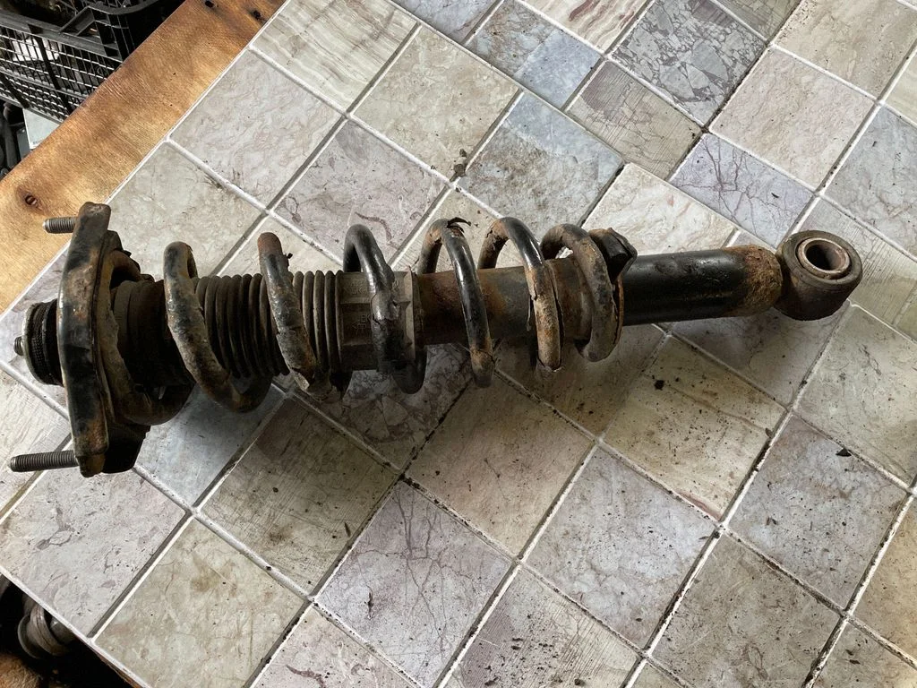 Rear shock absorber with coil spring – rear left