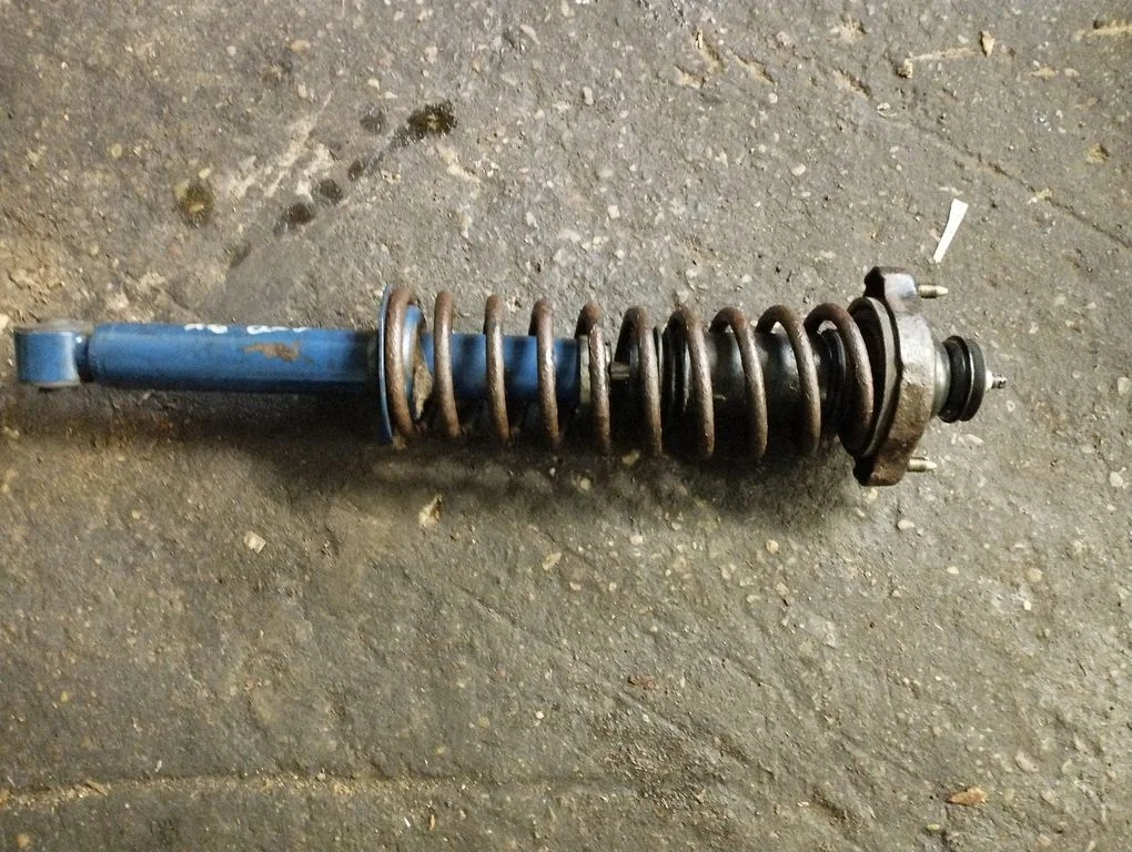 Rear shock absorber with coil spring – rear left