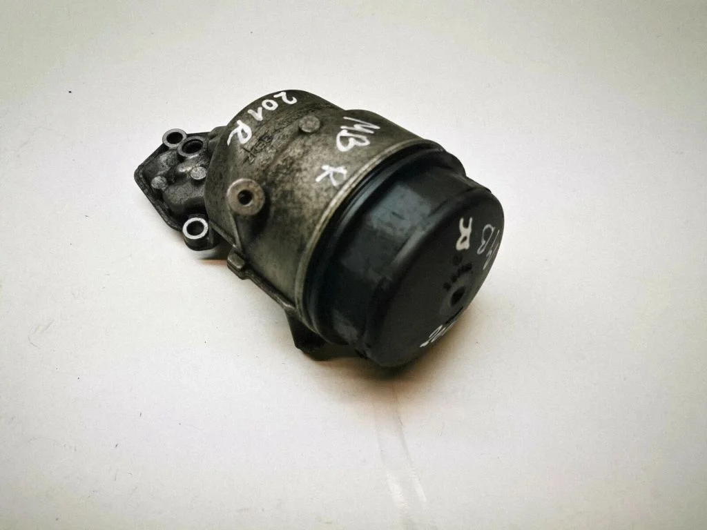 Oil filter mounting bracket – front